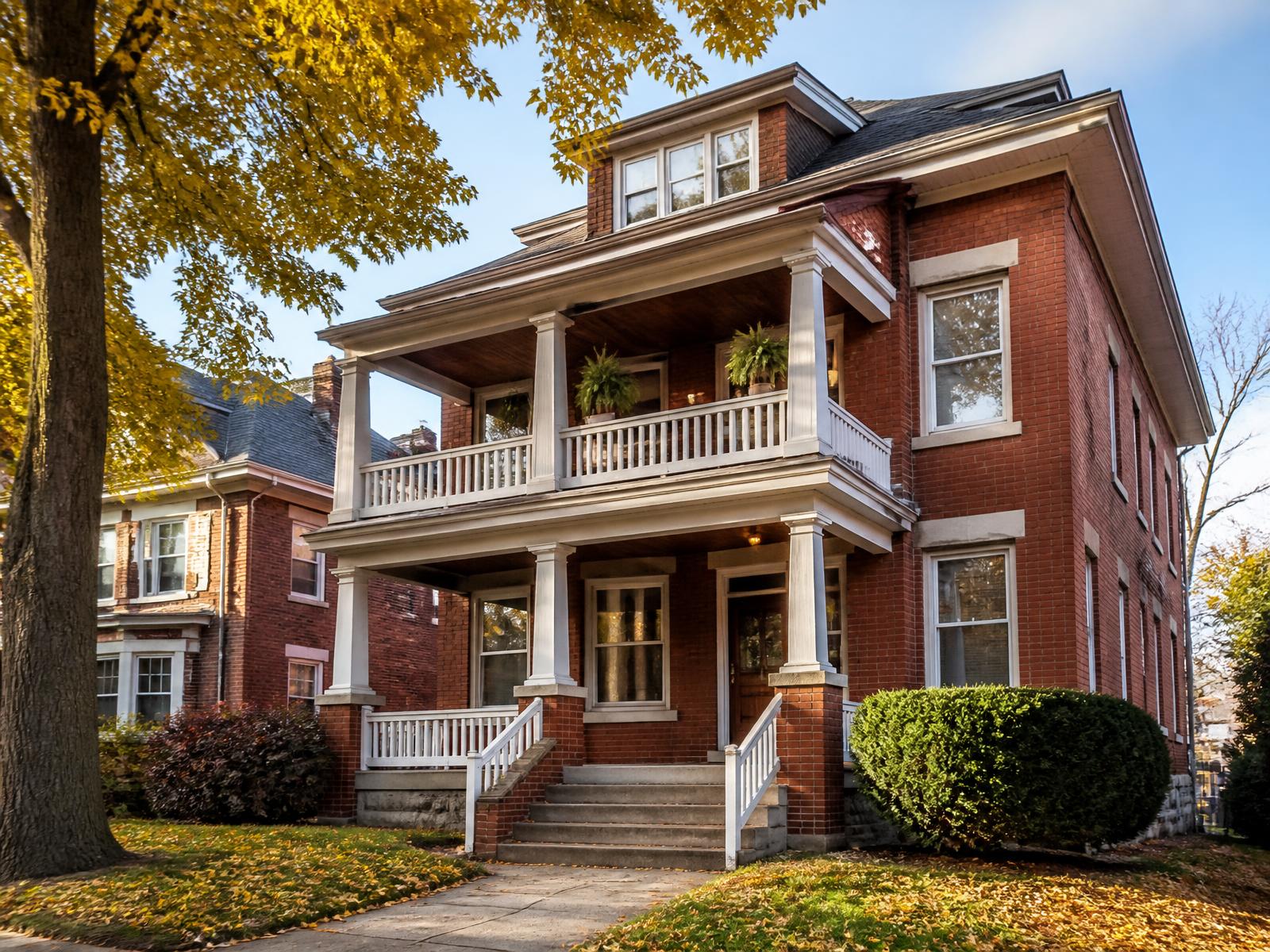 Brick two-family rental home on a tree-lined street in Rochester, New York